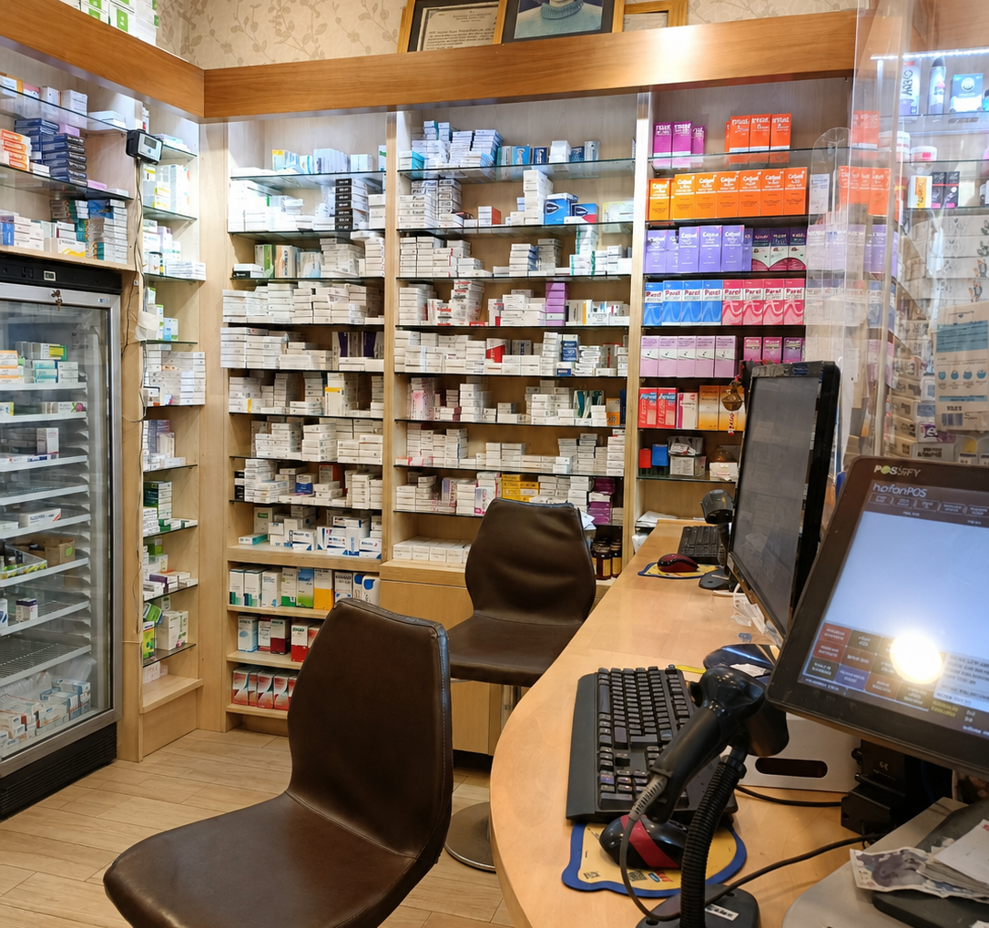 Professional pharmacy dispensing area with ergonomic counter and custom shelving by Pharm Art Studio