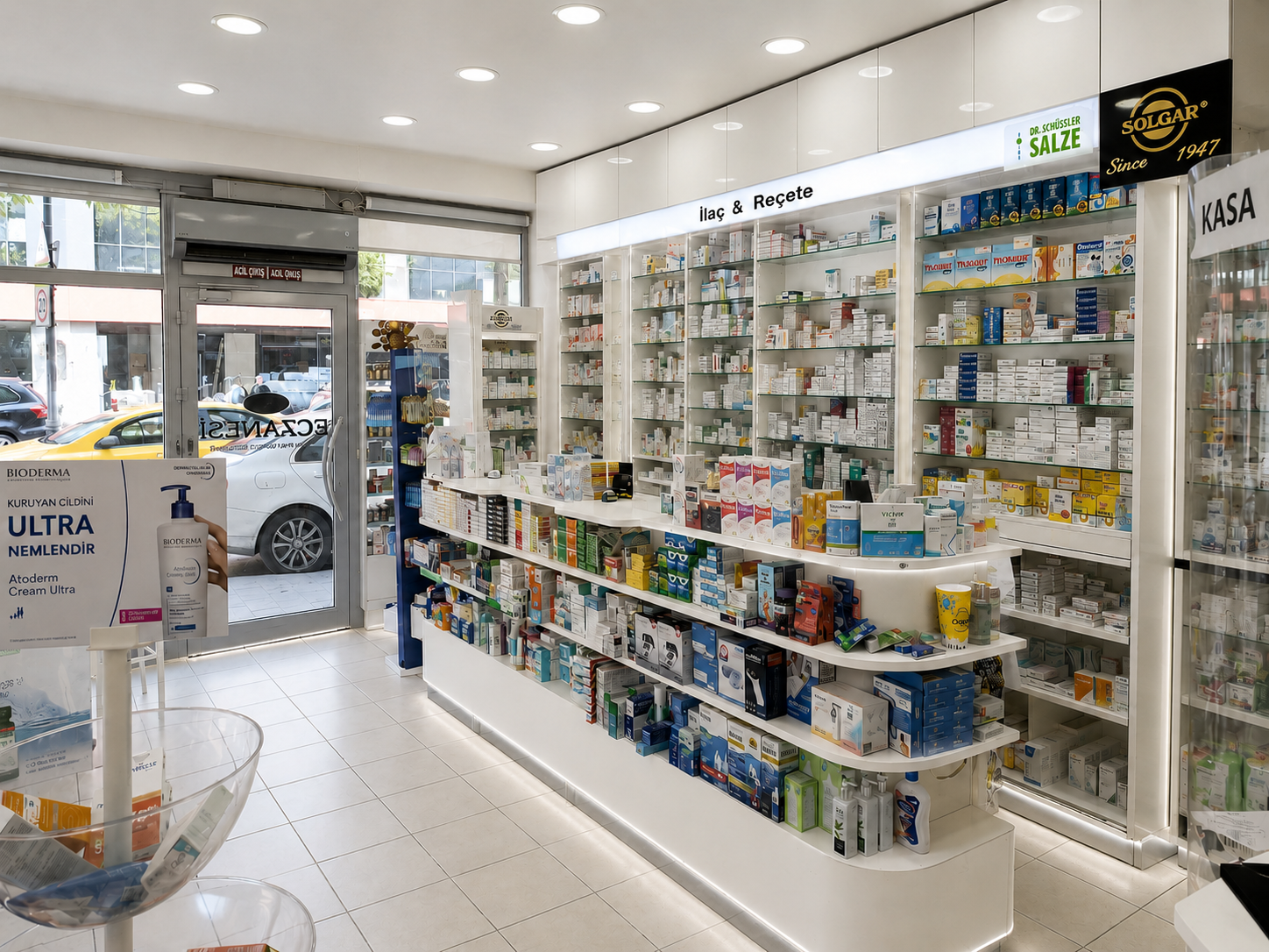 Modern pharmacy interior with central retail display, prescription counter and illuminated medicine shelving